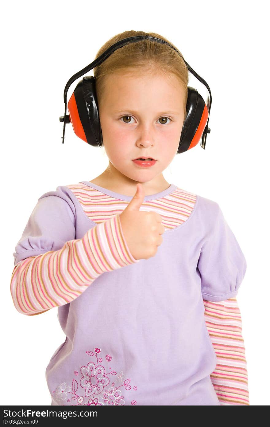 Little girl listening to music on white background