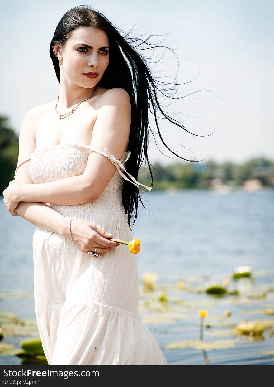 Pretty young woman portrait. On the riverside