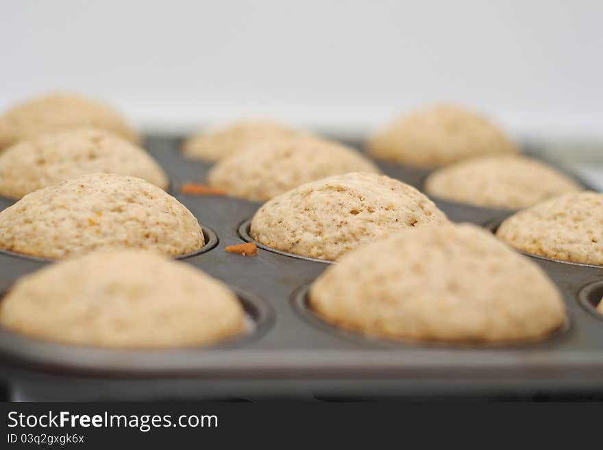 Freshly baked vanilla muffins resting in the tray