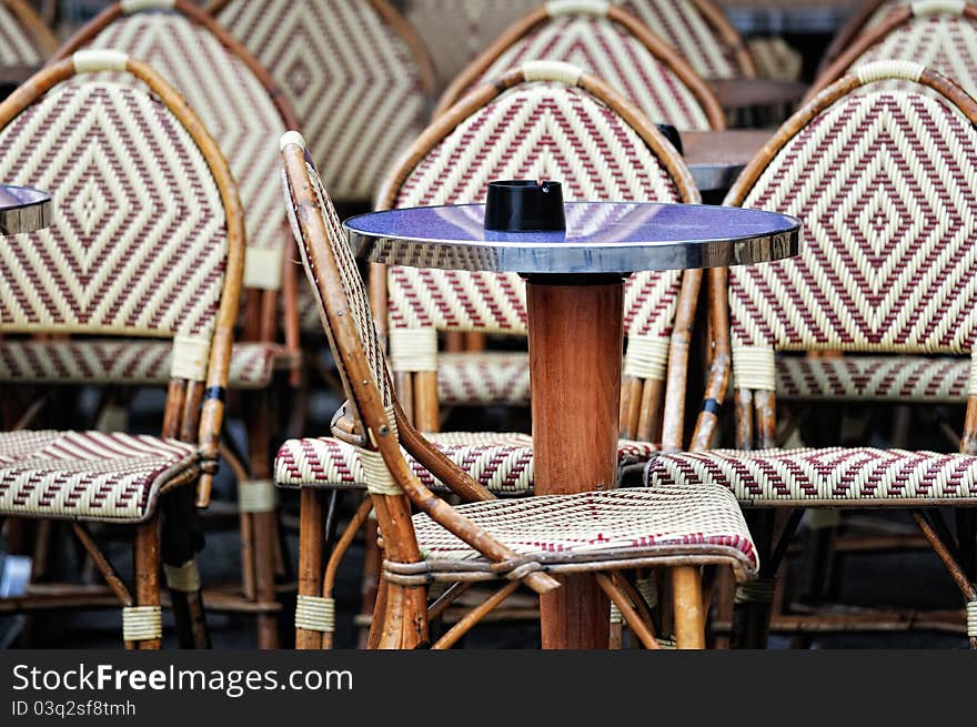 Wicker chairs and tables in the street cafe in Paris