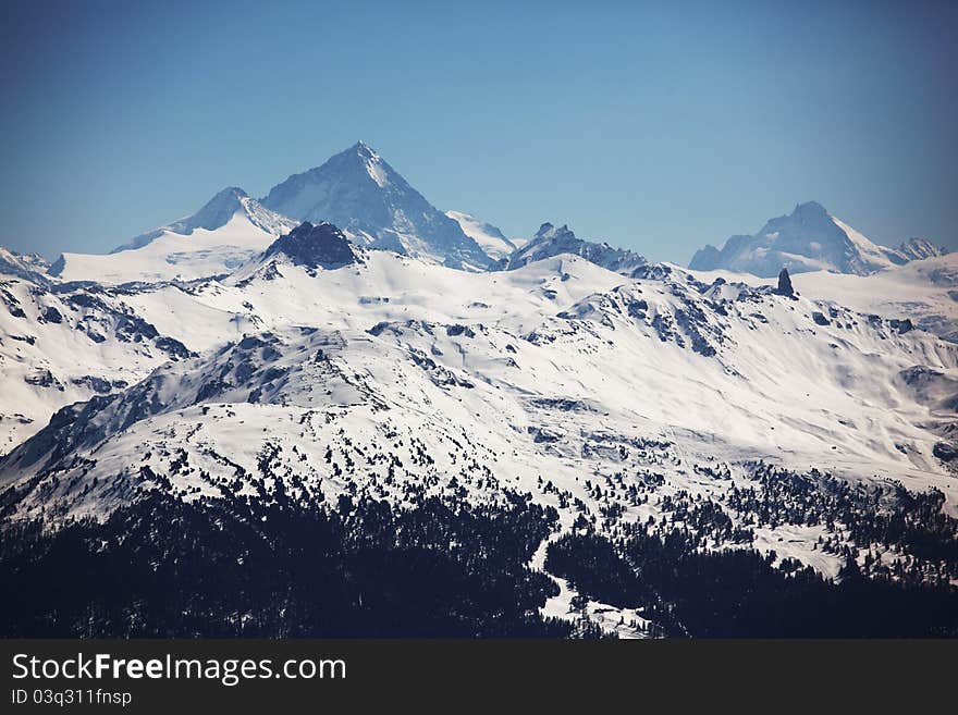 Top of mountains in blue sky