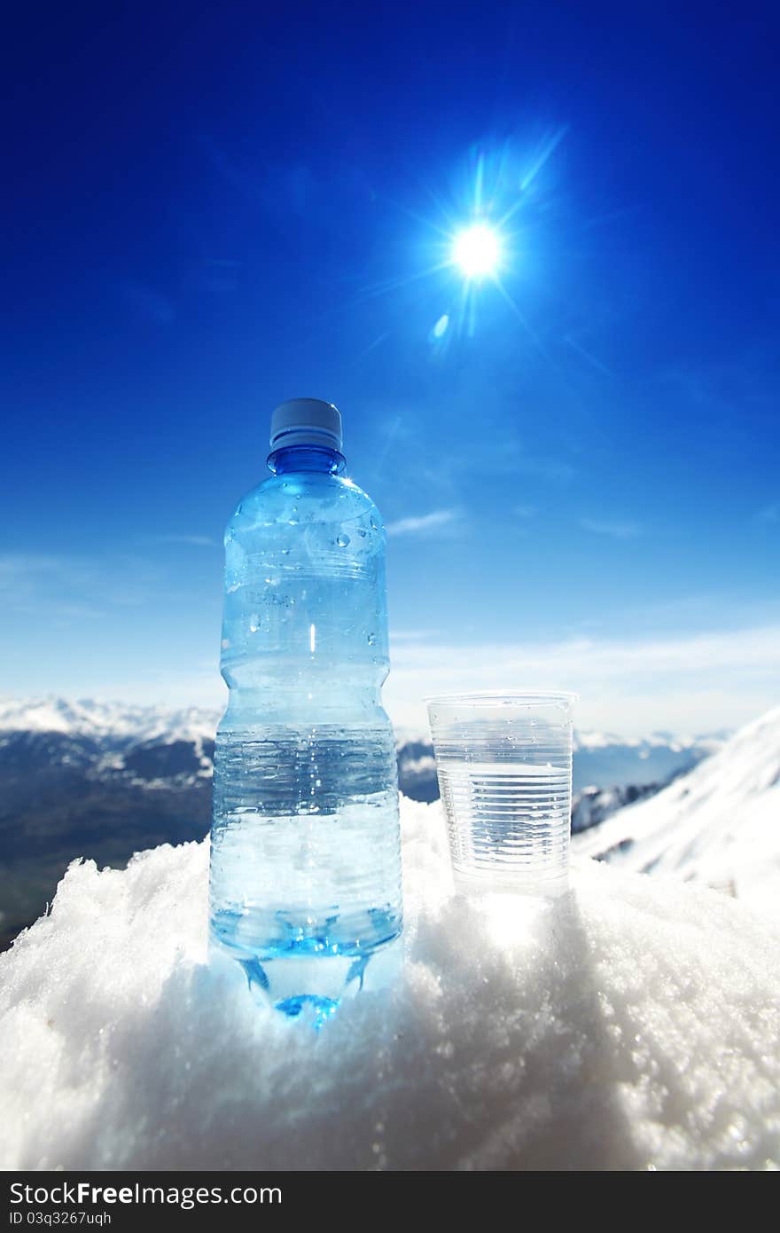 Water in cup mountains on background. Water in cup mountains on background