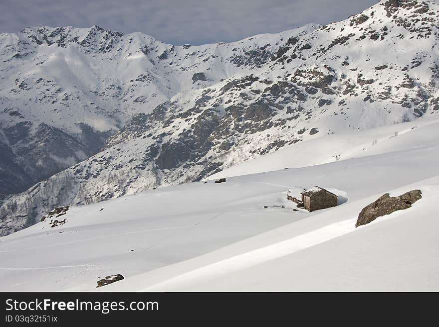 With snowy mountain huts in the Alps