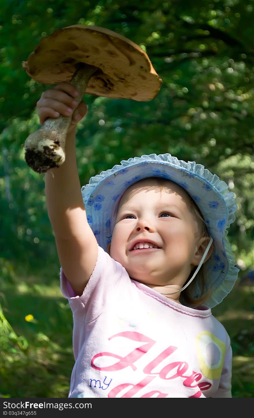 Little girl holding a big mushroom. Little girl holding a big mushroom