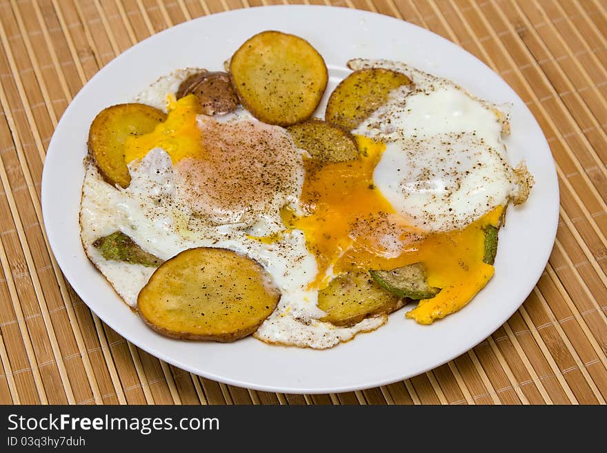 Scrambled eggs with vegetables on white plate