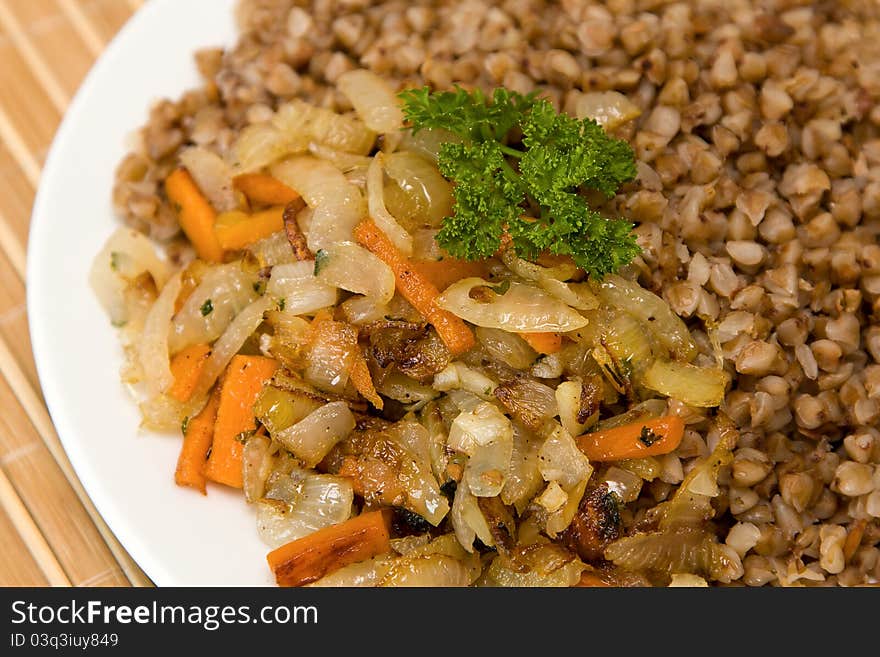 Buckwheat cereal with fried onions and carrots