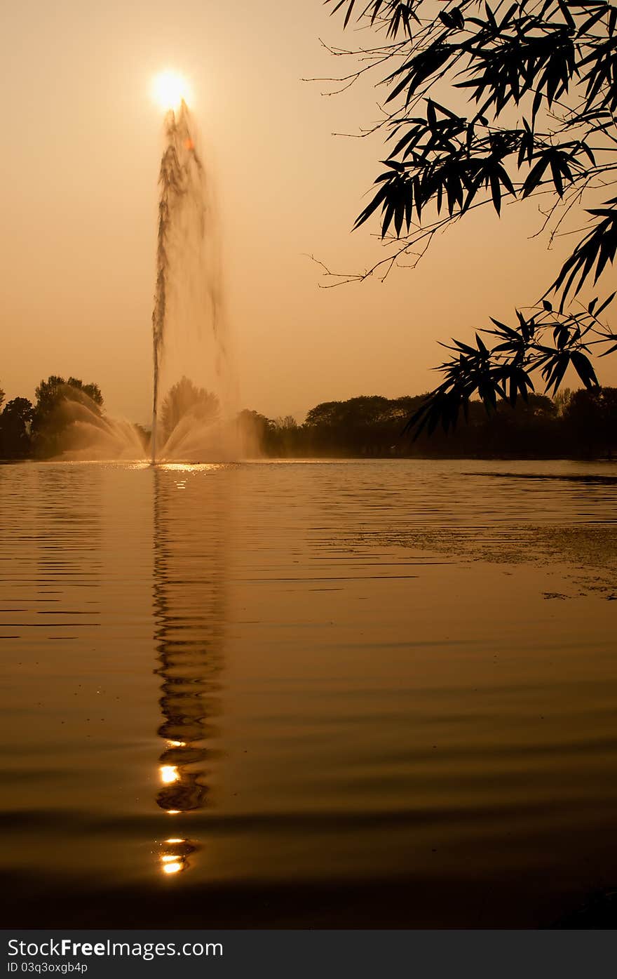 View of a fountain and water ripple with reflection on water surface. View of a fountain and water ripple with reflection on water surface