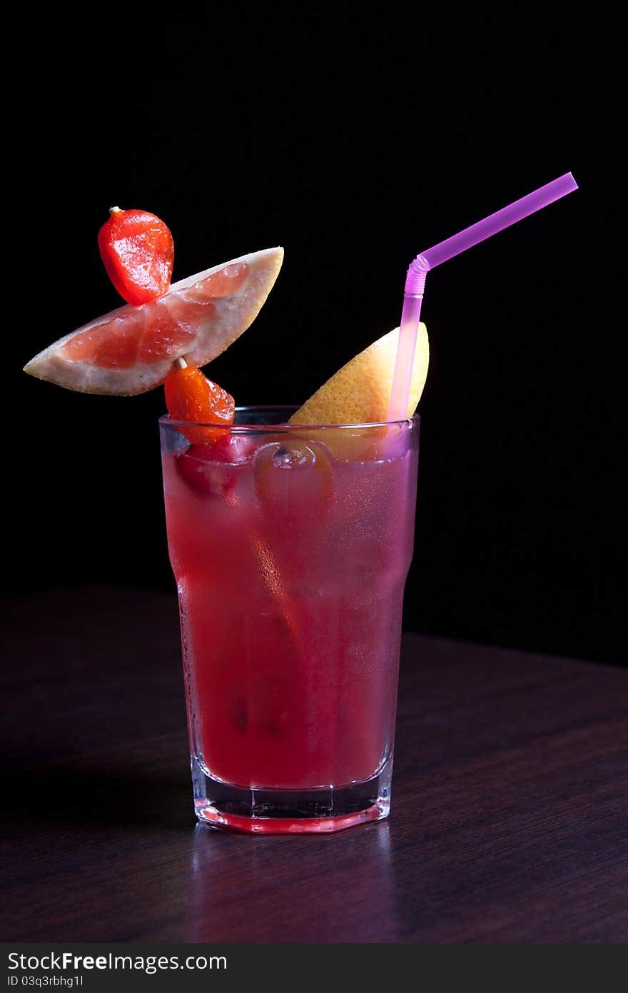 Tropical cocktail glass with fruits