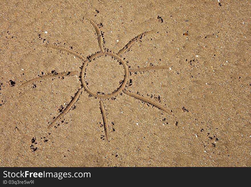 Children's drawing of the sun on sand