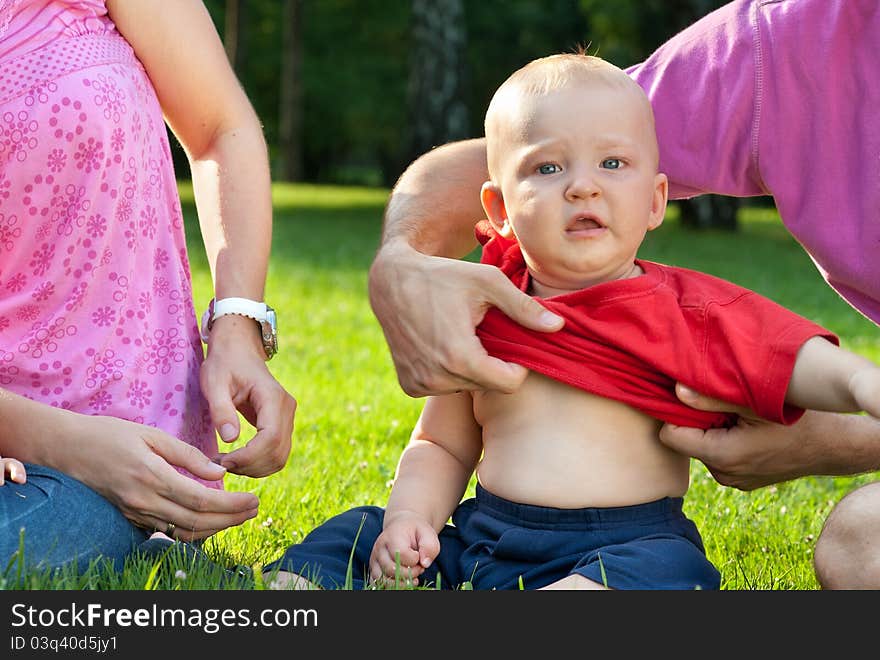 Parents undressing the little boy