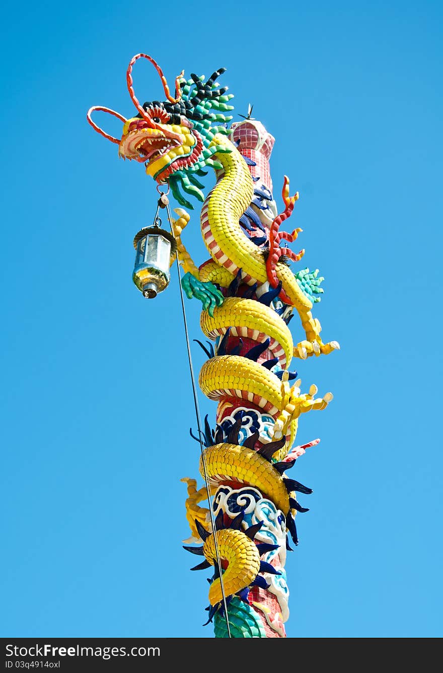 Photo dragon statue chinese style in the sky, no clouds. The Chinese believe that it is a sacred animal has the power and pleasure. Photo dragon statue chinese style in the sky, no clouds. The Chinese believe that it is a sacred animal has the power and pleasure
