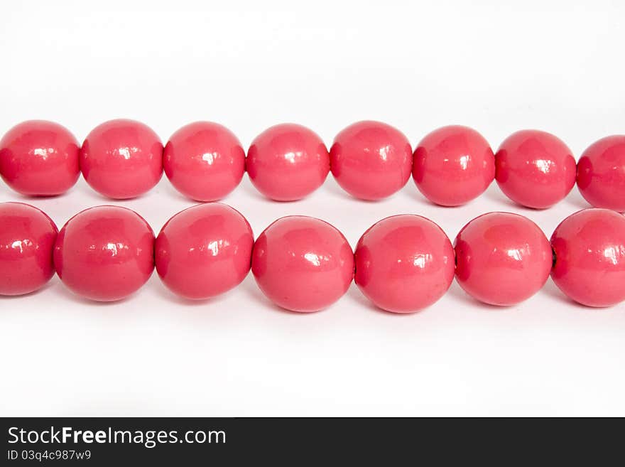 Pink beads on a white background