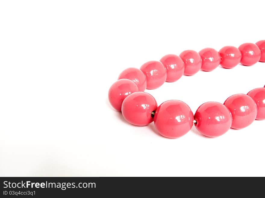 Curved pink beads on a white background