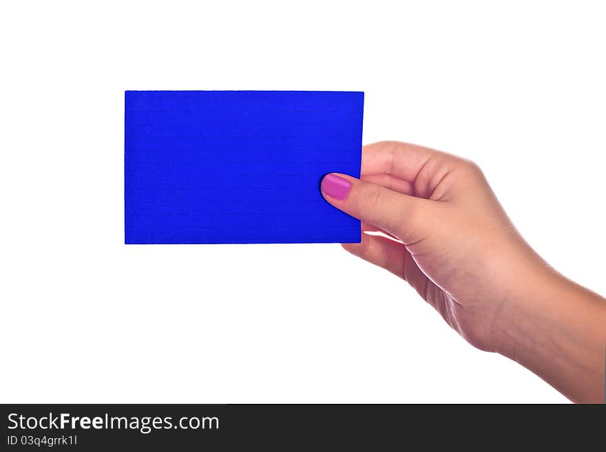 A hand holding a bright blue paper index card. A hand holding a bright blue paper index card