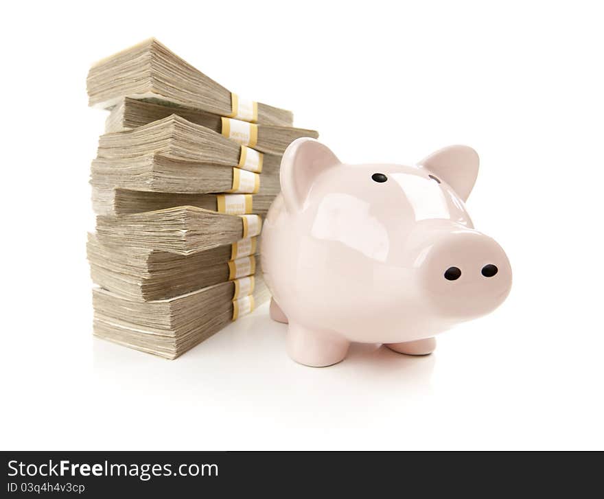 Pink Piggy Bank with Stacks of Hundreds of Dollars on a White Background. Pink Piggy Bank with Stacks of Hundreds of Dollars on a White Background.