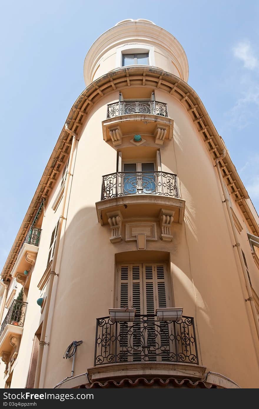 An elegant and ornate building in Monaco Ville, with balconies and stone carvings. An elegant and ornate building in Monaco Ville, with balconies and stone carvings