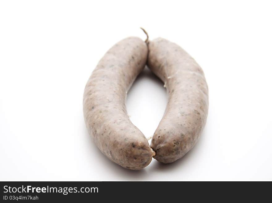 Raw fried sausage with cord on white background