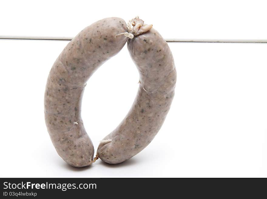 Raw fried sausage with cord on white background