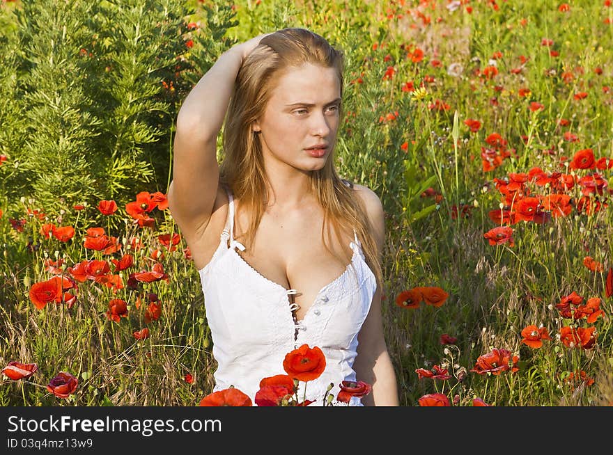 Portrait of a beautiful girl in the red poppies