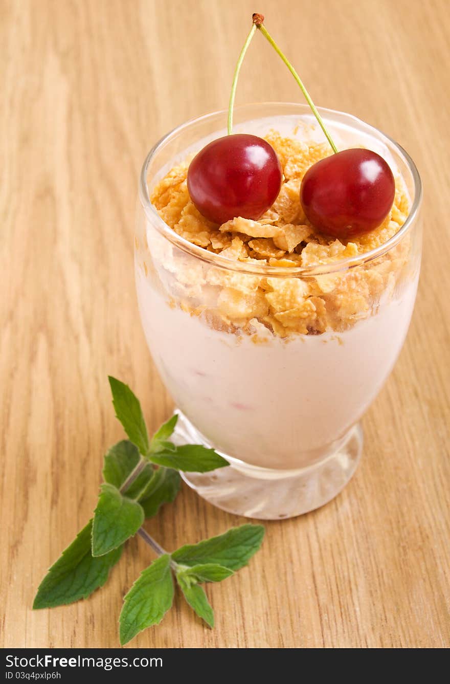 Glass of Cherry yogurt with flakes and fresh cherries