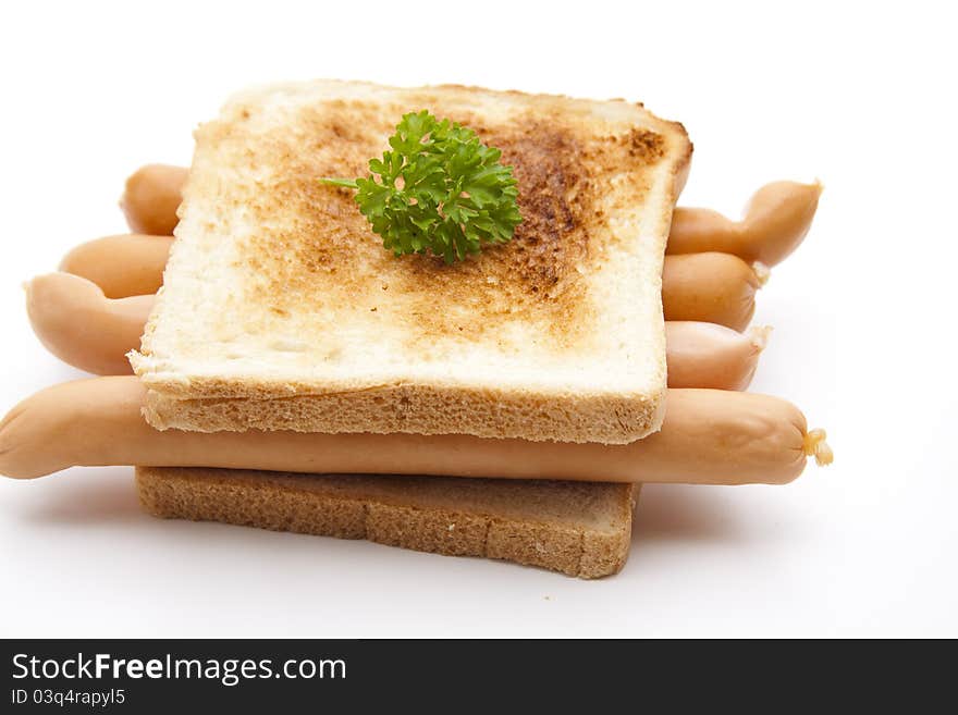 Frankfurter on toast bread with parsley on white background