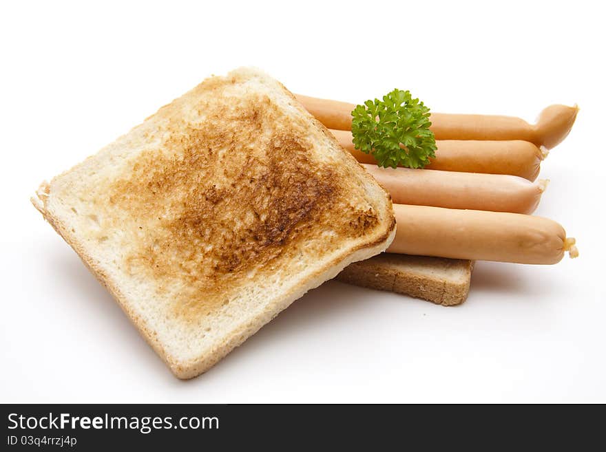 Frankfurter on toast bread with parsley on white background