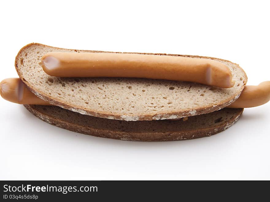 Frankfurter with bread on white background