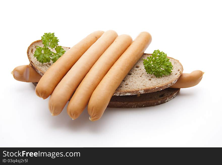 Frankfurter with bread on white background