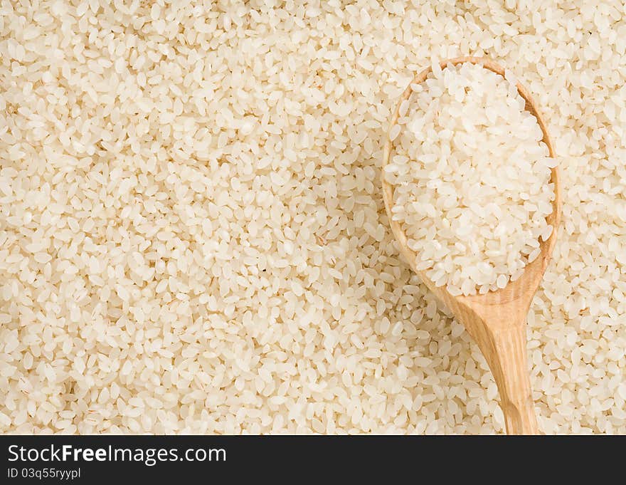 Rice grain and wooden spoon. Rice grain and wooden spoon