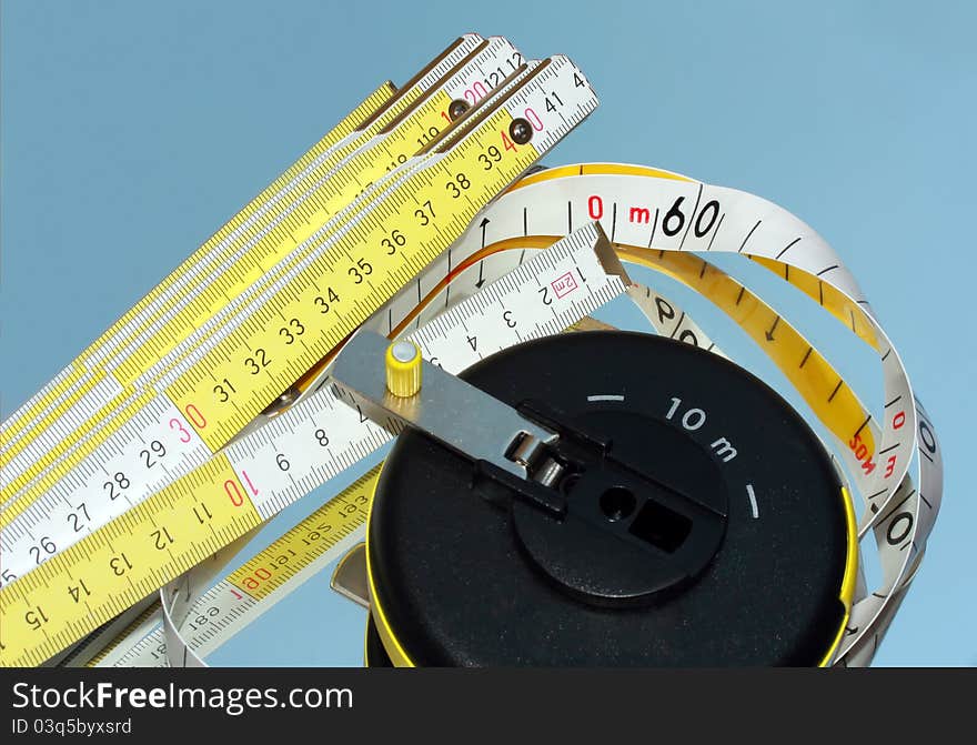 Two measure tools: wooden meter and Tape Measure