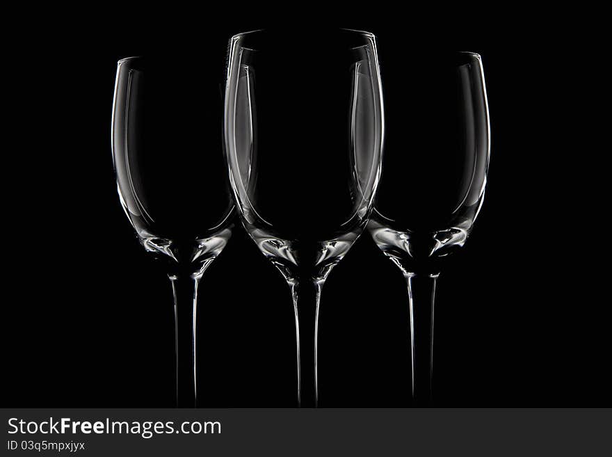 Three elegant black cups in a black background.