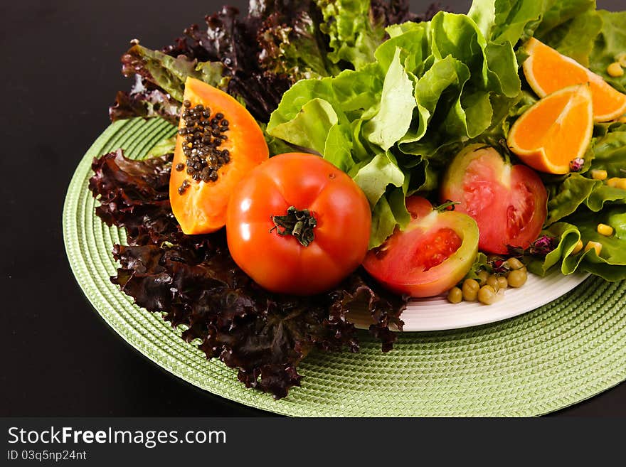 Composition of fruits and vegetables lettuce, orange, tomato, papaya