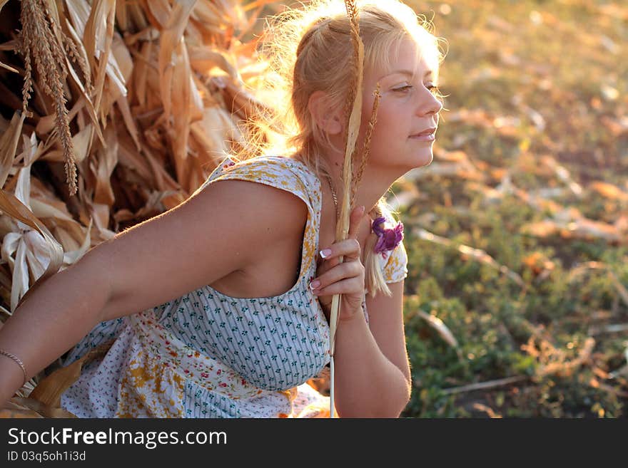 Girl in white dress walking in the green field. Girl in white dress walking in the green field