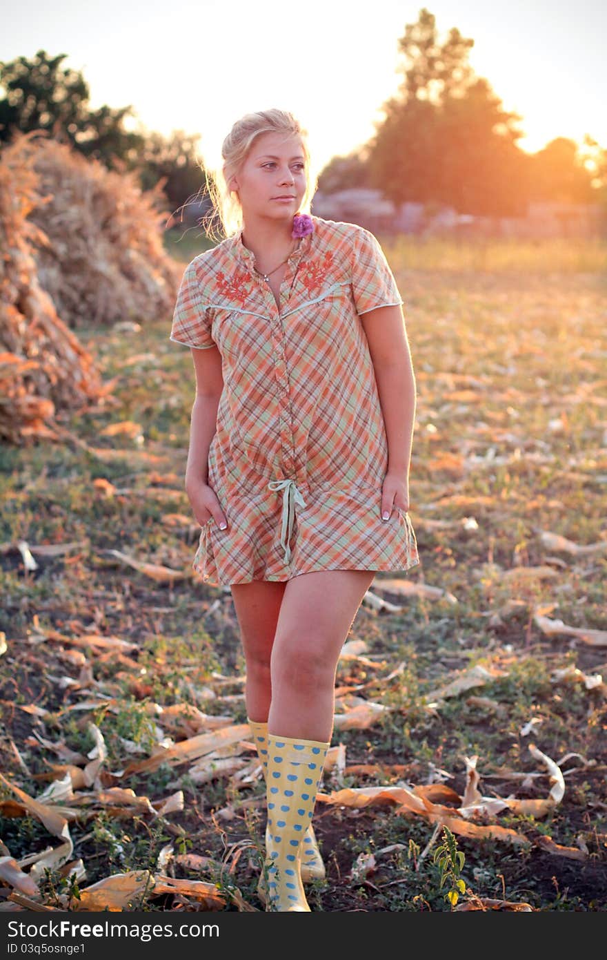 Young woman in corn haystack and sunset. Young woman in corn haystack and sunset