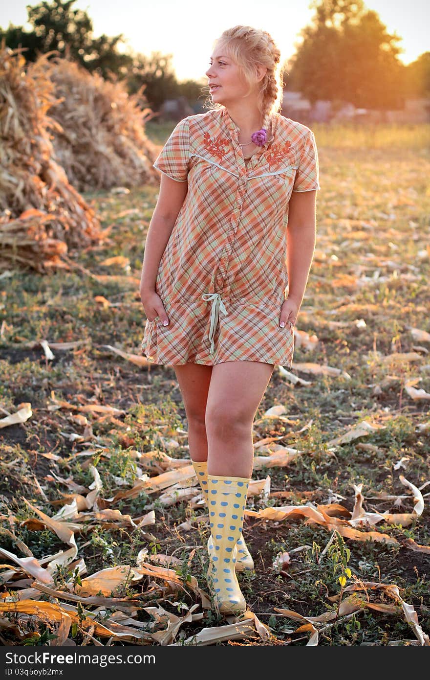 Young woman in corn haystack and sunset. Young woman in corn haystack and sunset