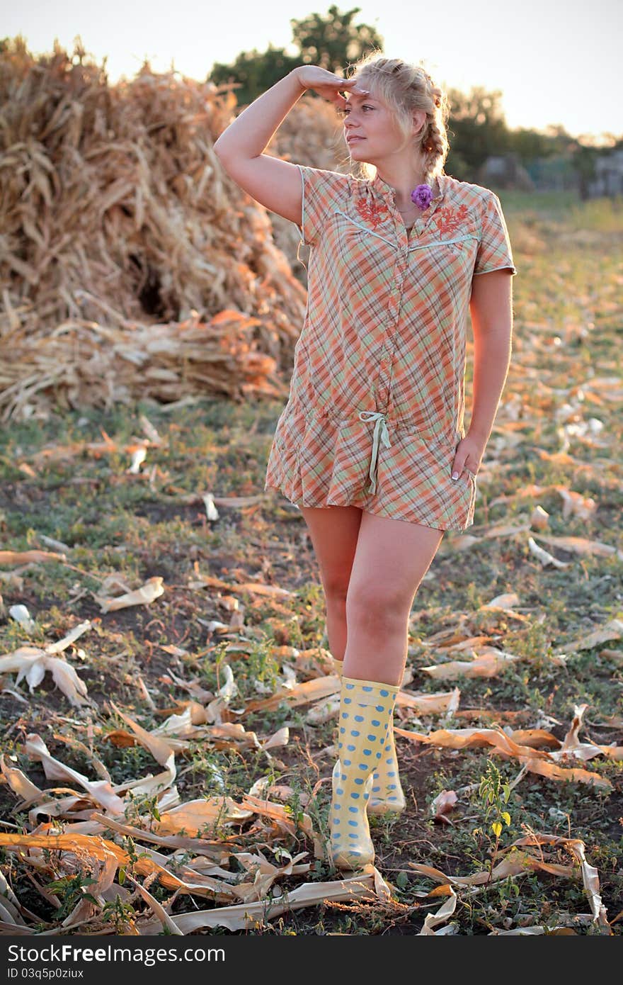 Young woman in corn haystack and sunset. Young woman in corn haystack and sunset