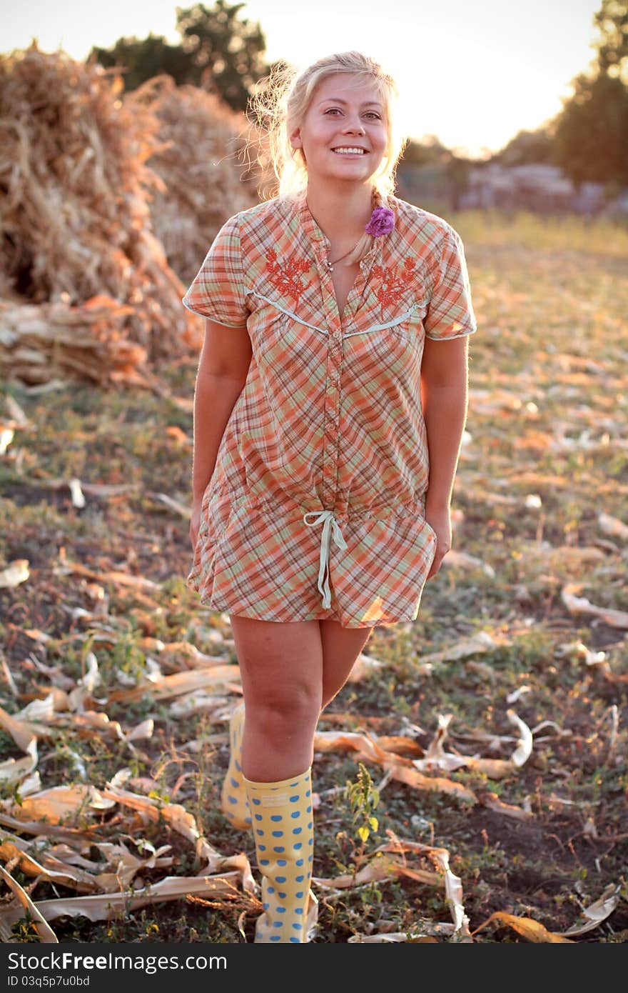 Young woman in corn haystack and sunset. Young woman in corn haystack and sunset