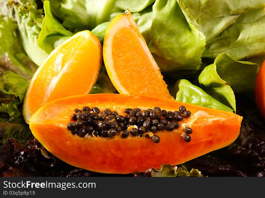 Composition of fruits and vegetables lettuce, orange, tomato, papaya