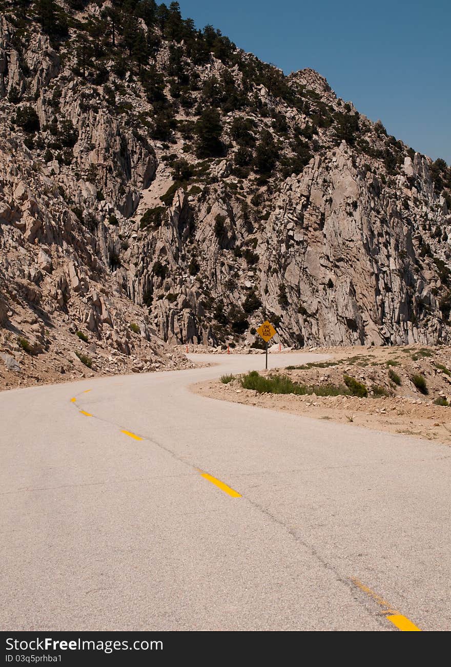 A single narrow windy road passes through the eastern sierra mountains of california. A single narrow windy road passes through the eastern sierra mountains of california.