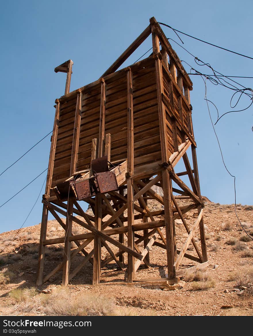 Abandoned mining structure stands tall in the desert. This structure was used to unload ore from and overhead tram bucket. The bucket ran on cables that now lay draped over the structure. Abandoned mining structure stands tall in the desert. This structure was used to unload ore from and overhead tram bucket. The bucket ran on cables that now lay draped over the structure.