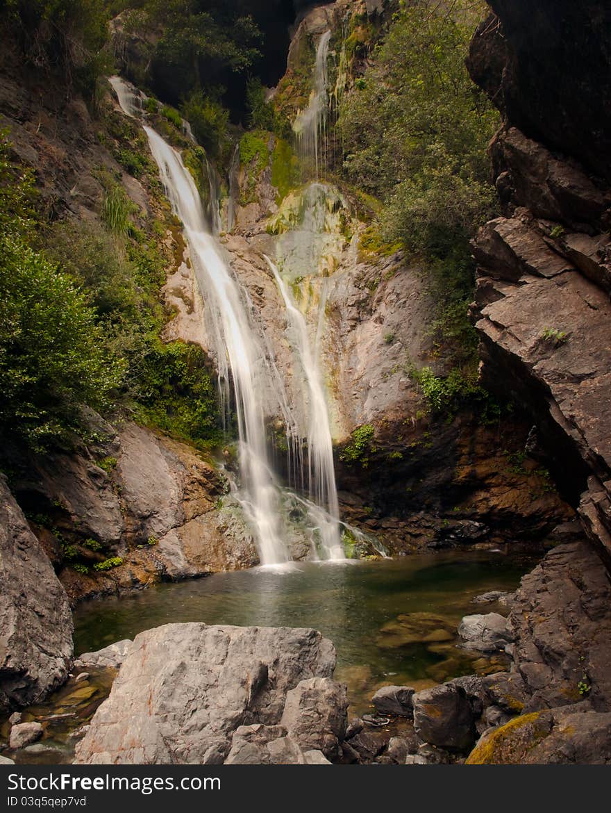 This streams of water cascade into a pristine pool of water. This streams of water cascade into a pristine pool of water.