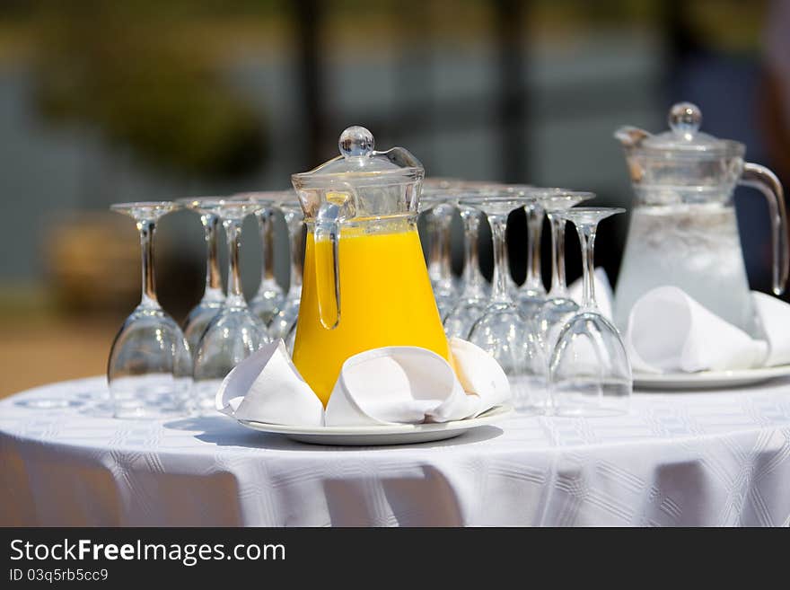 Orange juice and water in jugs at a wedding reception