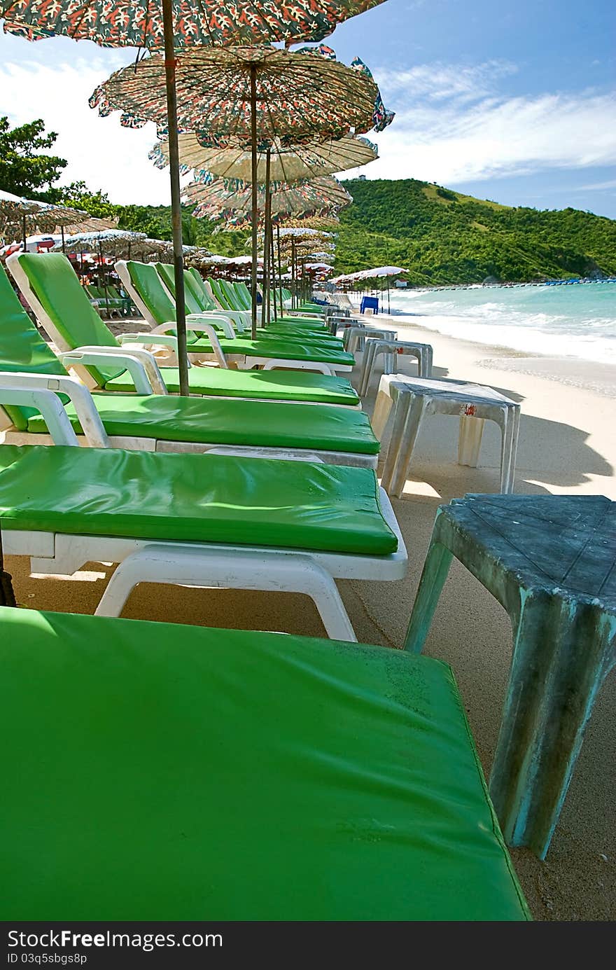 Beach chair and colorful umbrella on the beach , Koh Lan Thailand