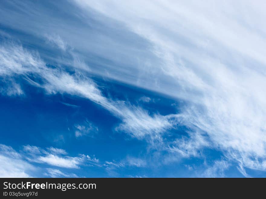 Wispy white Clouds on a blue sky