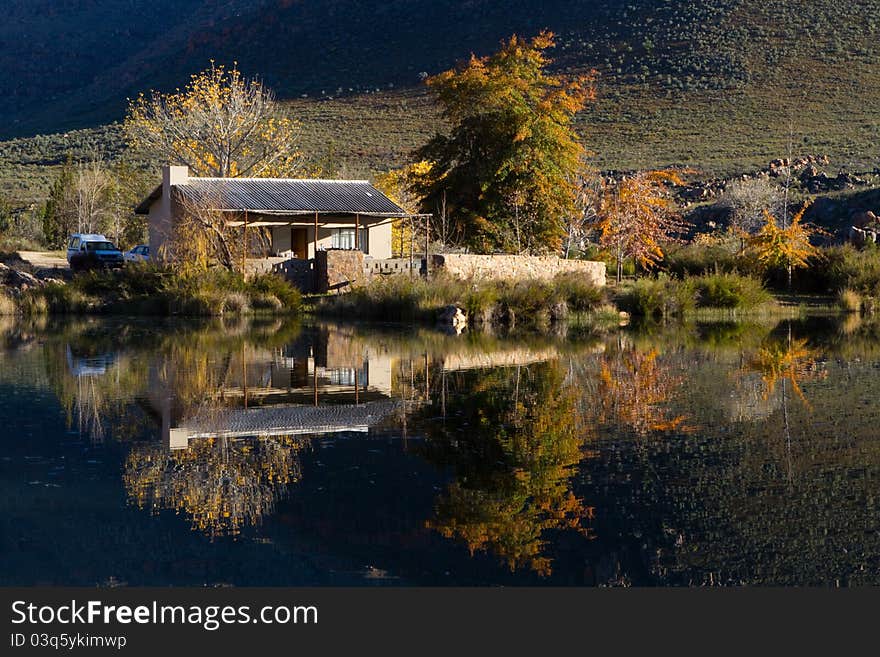 A small holiday home next to a lake with stunning reflextion in the water. A small holiday home next to a lake with stunning reflextion in the water