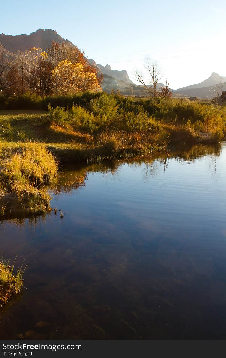 A colorful autumn scene next to a river