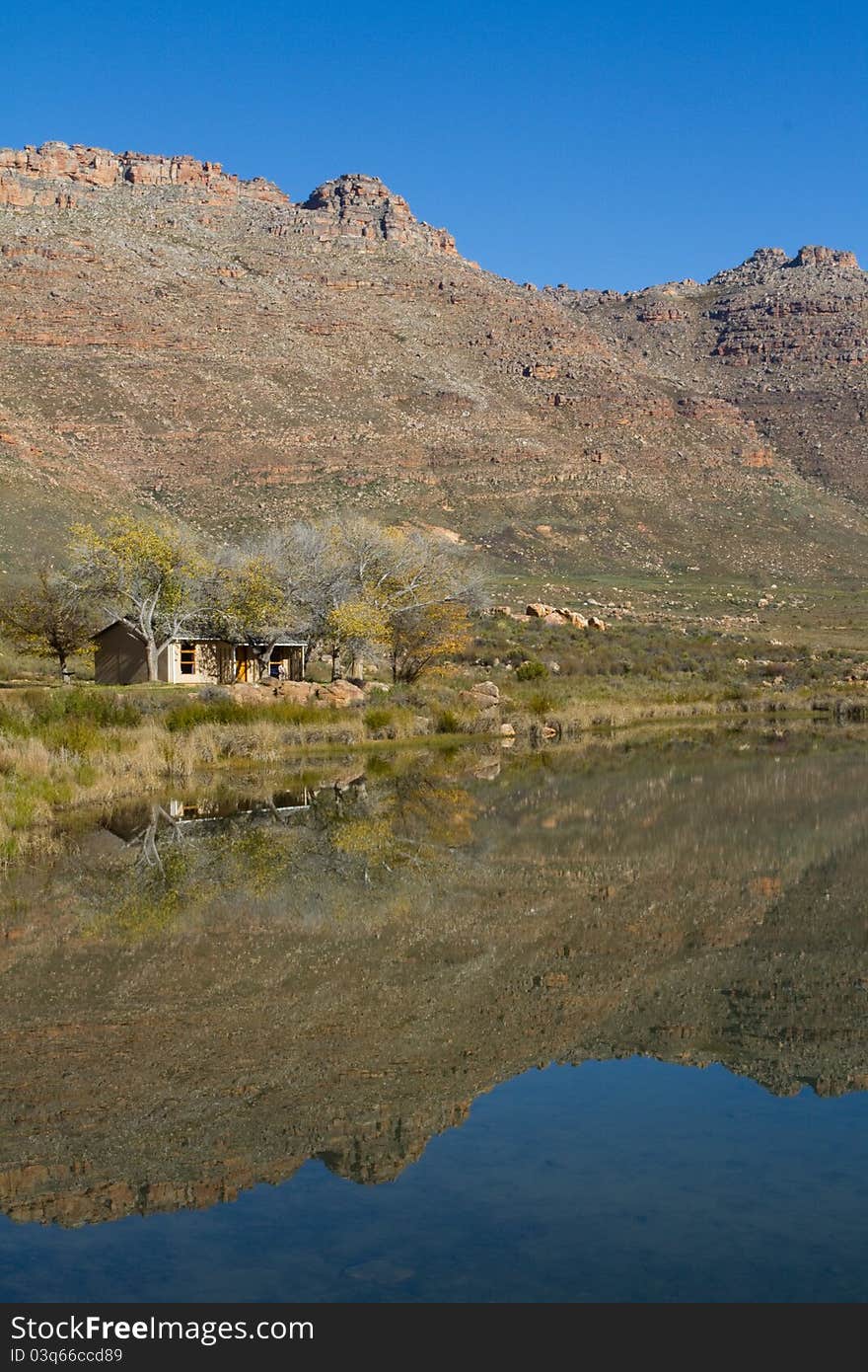 A small holiday home next to a lake with stunning reflextion in the water. A small holiday home next to a lake with stunning reflextion in the water