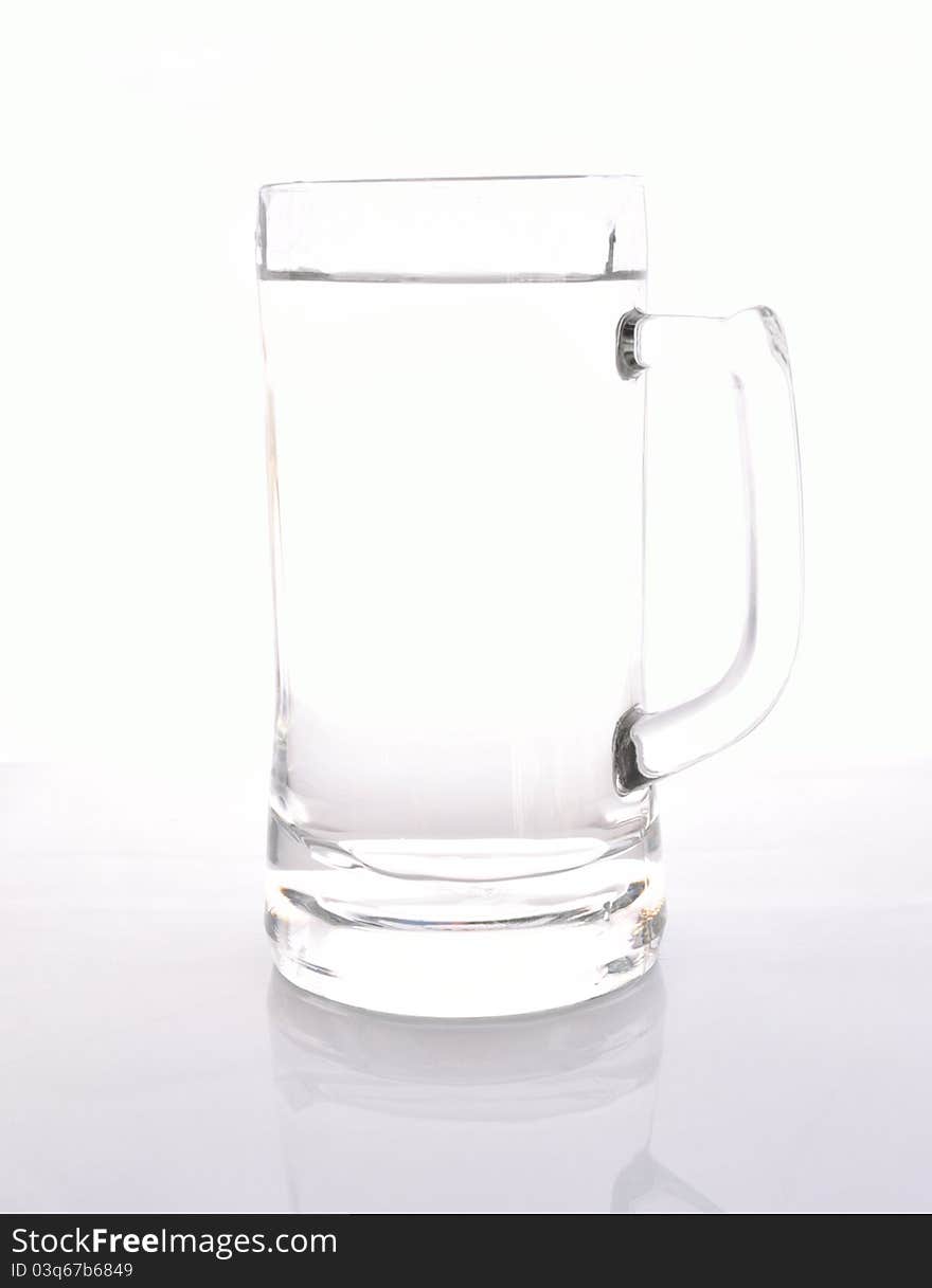 Attractive glass jug of water on white background.