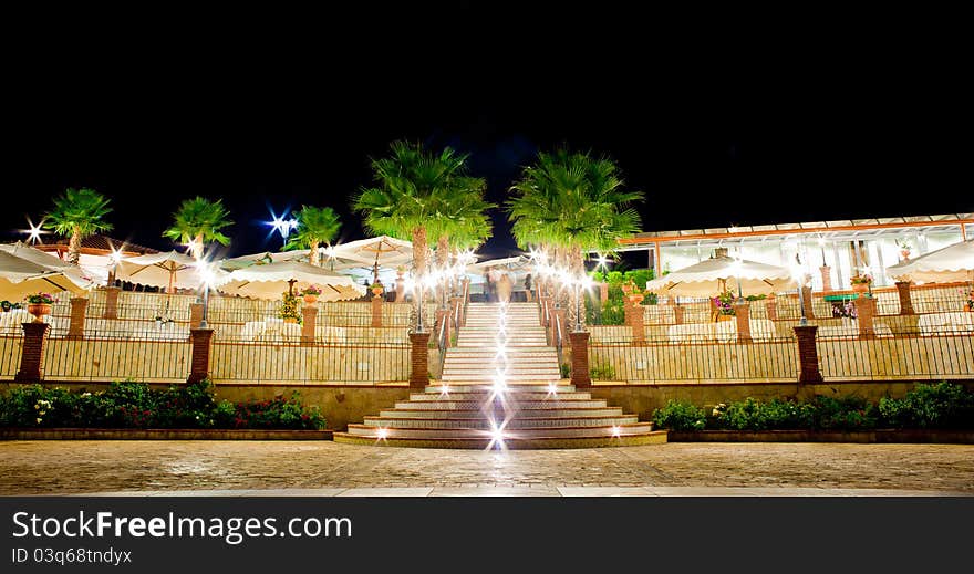 Night view of table set in the garden