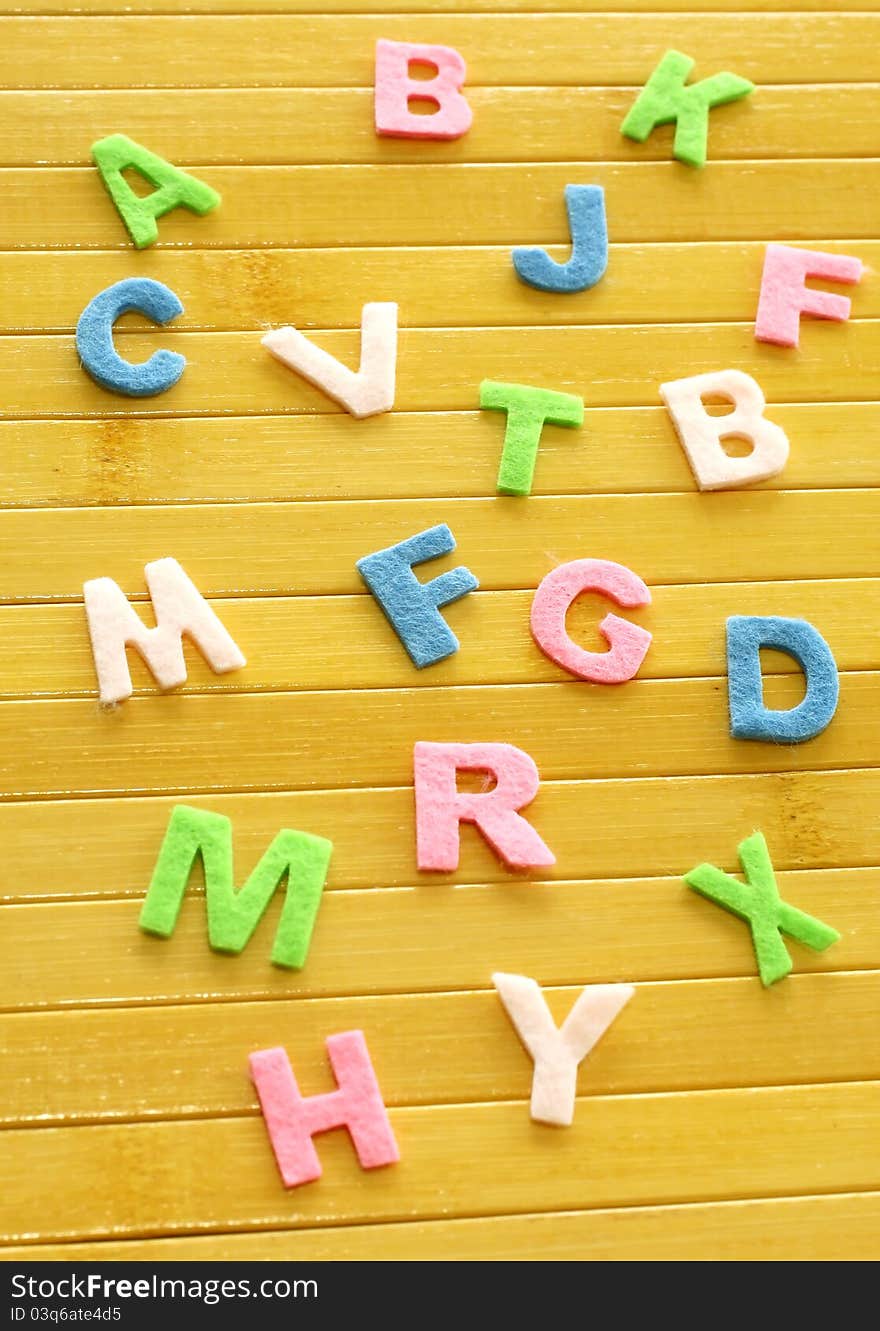 Color letters on wooden background